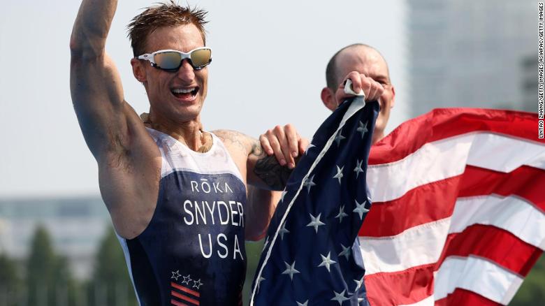 TOKYO, JAPAN - AUGUST 28: Brad Snyder and guide Greg Billington of Team United States react as they cross the finish line to win the gold medal during the men's PTVI Triathlon on day 4 of the Tokyo 2020 Paralympic Games at Odaiba Marine Park on August 28, 2021 in Tokyo, Japan. (Photo by Lintao Zhang/Getty Images)