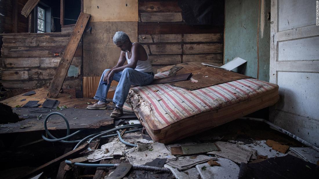 Theophilus Charles, 70, sits inside his damaged home in Houma, Louisiana, on Monday, August 30.