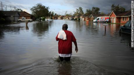 A resident walks through floodwater left behind by Hurricane Ida in LaPlace, Louisiana, on August 30, 2021. 