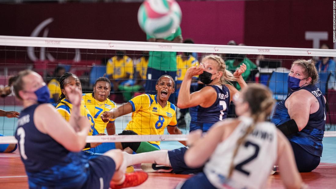 Rwanda&#39;s Carine Kwizera, center, reacts after spiking a ball during a sitting volleyball match against the United States on August 28.