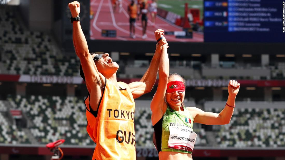 Mexico&#39;s Mónica Olivia Rodriguez and her guide, Kevin Teodoro Aguilar Perez, react after she won gold in a 1,500-meter race on August 30.