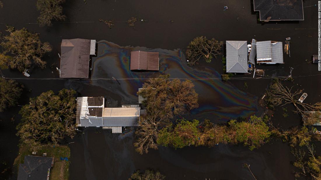 An oil slick is seen on top of floodwaters in Kraemer, Louisiana, on Monday.