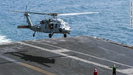 An MH-60S Knighthawk helicopter lands on the flight deck of the aircraft carrier USS Harry S. Truman