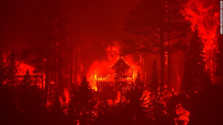 The Caldor Fire burns homes along a ridge near South Lake Tahoe, California, on August 30, 2021.