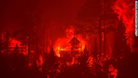 The Caldor Fire burns homes along a ridge near South Lake Tahoe, California, on August 30, 2021.