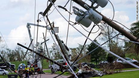 Crews begin work on downed power lines leading to a fire station on Tuesday in  Waggaman, Louisiana.