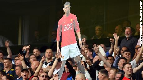 Manchester United fans hold up a cardboard cut out of Cristiano Ronaldo during their Premier League match at Wolves.