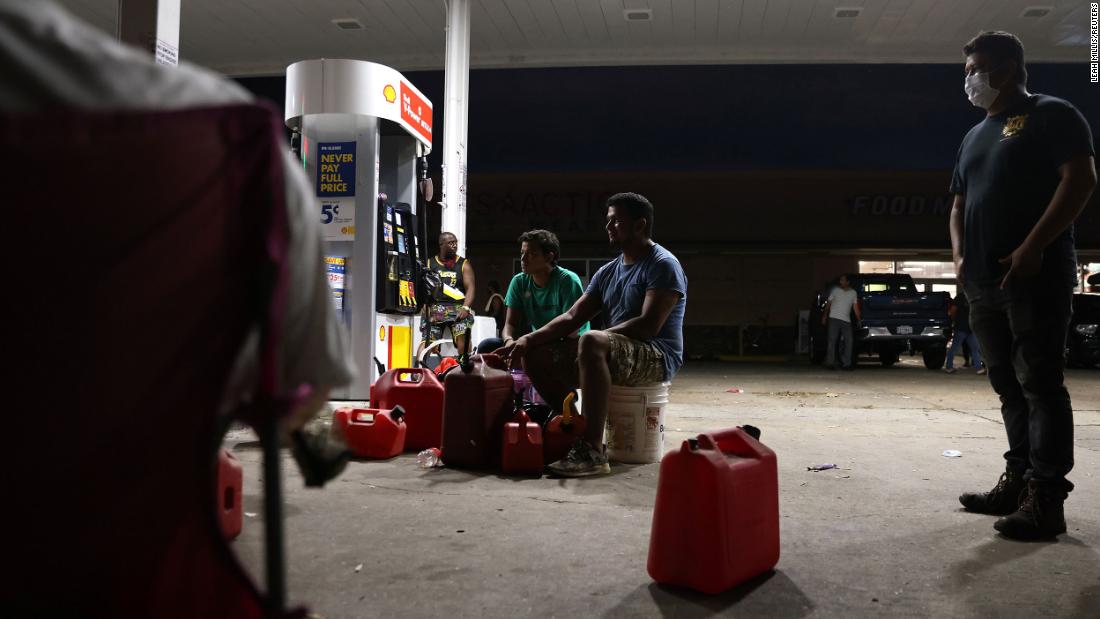 People wait for a gas truck to arrive at a gas station in New Orleans on August 31.