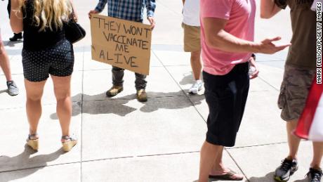 Anti-vaccine rally protesters hold signs outside of Houston Methodist Hospital in Houston, Texas, on June 26, 2021. 