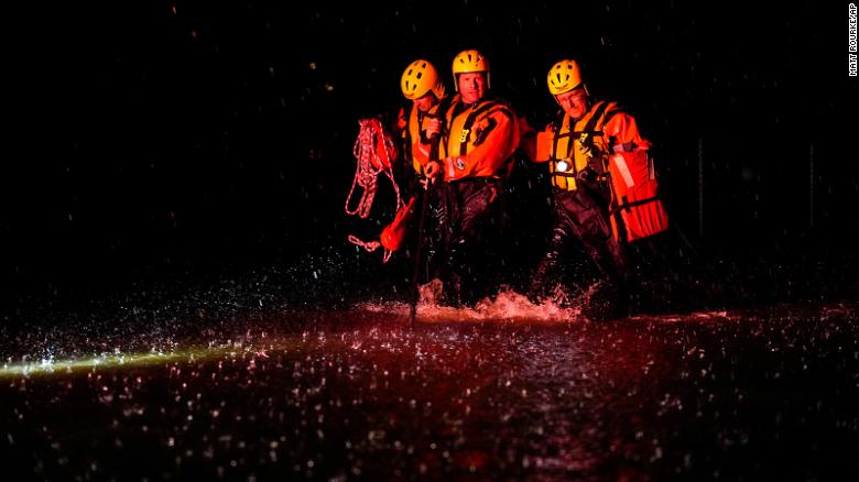 Members of the Weldon Fire Company walk through floodwaters in Dresher, Pennsylvania, on September 1.