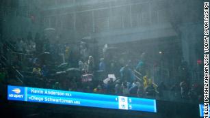 Rain falls into Louis Armstrong Stadium during the second-round match between Diego Schwartzman and Kevin Anderson.