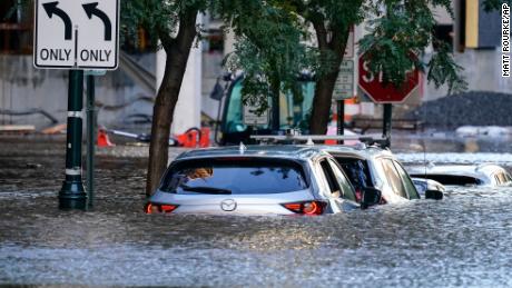 Vehicles are seen under floodwater in Philadelphia on Thursday. 