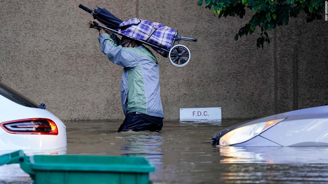 A person walks in floodwaters in Philadelphia on September 2.