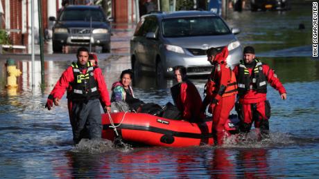 First responders pull local residents in a boat as they perform rescues of people trapped by floodwaters after the remnants of Tropical Storm Ida brought drenching rain, flash floods and tornadoes to parts of the northeast in Mamaroneck, New York, U.S., September 2, 2021. REUTERS/Mike Segar