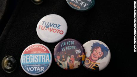 An attendee wears Spanish-language buttons during a campaign event for Democratic Senate candidate Jon Ossoff in Lilburn, Georgia, on December 7, 2020. 