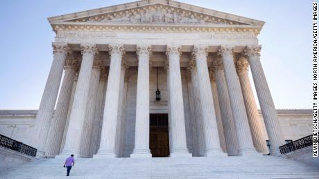WASHINGTON, DC - SEPTEMBER 02: A person walks on the steps of the U.S. Supreme Court on September 02, 2021 in Washington, DC. The Supreme Court voted 5-4 not to stop a Texas law that prohibits most abortions after six weeks of pregnancy. (Photo by Kevin Dietsch/Getty Images)