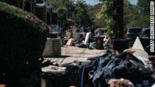 Residents sort through damaged and destroyed items in the Flushing neighborhood of the Queens borough of New York City. 