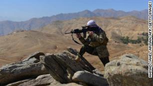 An anti-Taliban fighter takes a position during a patrol on a hilltop in Darband area in Anaba district, Panjshir province on September 1.