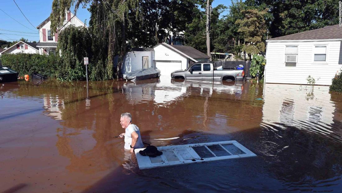 A man wades through floodwaters in Manville, New Jersey, on September 2.