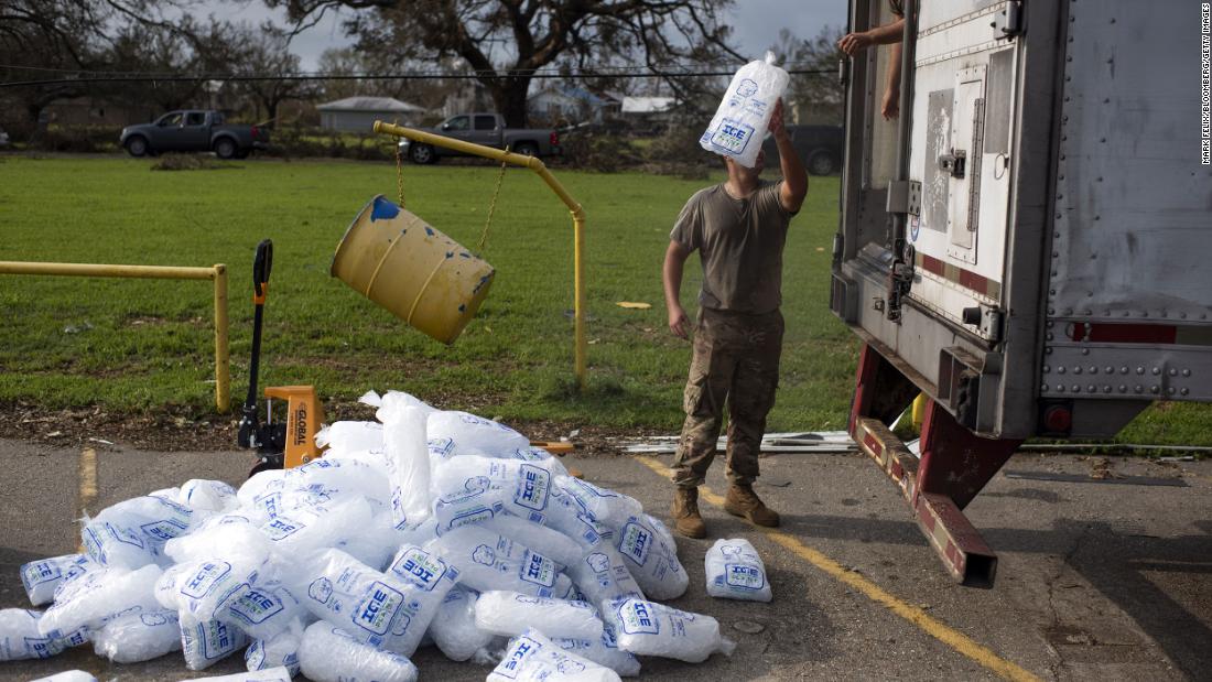 National Guard members unload ice at a distribution center in Montegut, Louisiana, on Thursday.