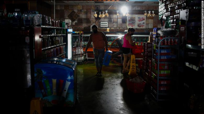 Shoppers buy supplies at a grocery store in New Orleans despite the power still being out on Thursday, September 2.