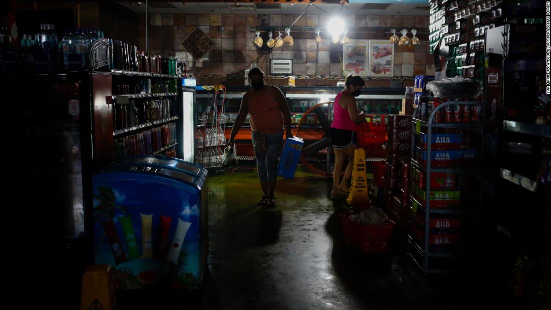 Shoppers buy supplies at a grocery store in New Orleans despite the power still being out on Thursday, September 2.