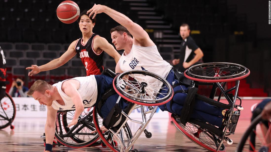 Great Britain&#39;s Lee Manning, right, passes the ball as he collides with teammate Gregg Warburton during a wheelchair basketball game against Japan on September 3.