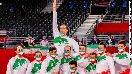 The Iranian team celebrates successfully defending its sitting volleyball title at the Paralympics. 