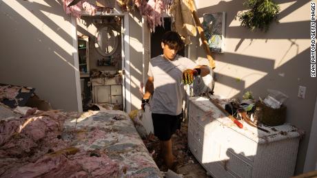 Michael Szeplaki helps to clean up his family&#39;s vacation house in the wake of Hurricane Ida on Saturday in Grand Isle, Louisiana.