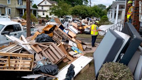 Utility workers work Sunday among debris from flood damage caused by the remnants of Hurricane Ida in Manville, New Jersey.