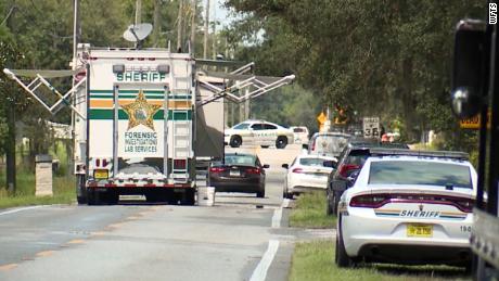 Law enforcement vehicles gathered by the scene of a quadruple homicide outside Lakeland, Florida.
