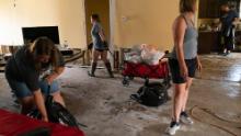 Cassie Falgoust, left, and her sister Michelle Smith, right, help clean out their parents&#39; home.