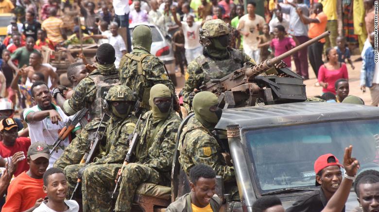 People celebrate in the streets with members of Guinea&#39;s armed forces after the arrest of Guinea&#39;s president, Alpha Conde, in a coup d&#39;etat in Conakry, September 5, 2021. 