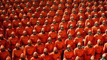 Personnel in orange hazmat suits march during a paramilitary parade held to mark the 73rd founding anniversary of the republic at Kim Il Sung square in Pyongyang in this undated image supplied by North Korea&#39;s Korean Central News Agency on September 9, 2021.    KCNA via REUTERS    ATTENTION EDITORS - THIS IMAGE WAS PROVIDED BY A THIRD PARTY. REUTERS IS UNABLE TO INDEPENDENTLY VERIFY THIS IMAGE. NO THIRD PARTY SALES. SOUTH KOREA OUT. NO COMMERCIAL OR EDITORIAL SALES IN SOUTH KOREA.     TPX IMAGES OF THE DAY