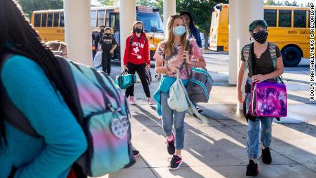 Students arrive on August 23, 2021 by bus for the first day of school at Kernodle Middle School in Greensboro, North Carolina. 