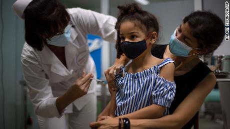 A girl gets a dose of the Cuban made Soberana-02 vaccine for COVID-19 in Havana, Cuba, Tuesday, Aug. 24, 2021. (AP Photo/Ramon Espinosa) 