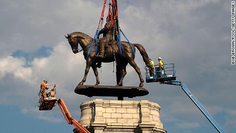 A statue of Confederate Gen. Robert E. Lee is removed from its pedestal on Monument Avenue on September 8, 2021, in Richmond, Virginia.