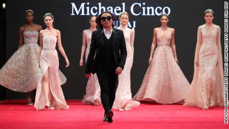 DUBAI, UNITED ARAB EMIRATES - DECEMBER 13:  Fashion designer Michael Cinco with models walk the red carpet after his show during D3 Presents: DIFF Fashion Forward on day seven of the 13th annual Dubai International Film Festival held at the Madinat Jumeriah Complex on December 13, 2016 in Dubai, United Arab Emirates.  (Photo by Neilson Barnard/Getty Images for DIFF)