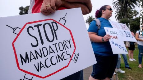 Anti-vaccination protesters holding signs take part in a rally against Covid-19 vaccine mandates, in Santa Monica, California, on August 29, 2021. (Photo by RINGO CHIU / AFP) (Photo by RINGO CHIU/AFP via Getty Images)