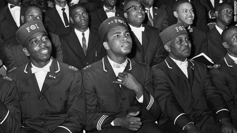 Muhammad Ali listens to Elijah Muhammad as he speaks to other black Muslims in Chicago.