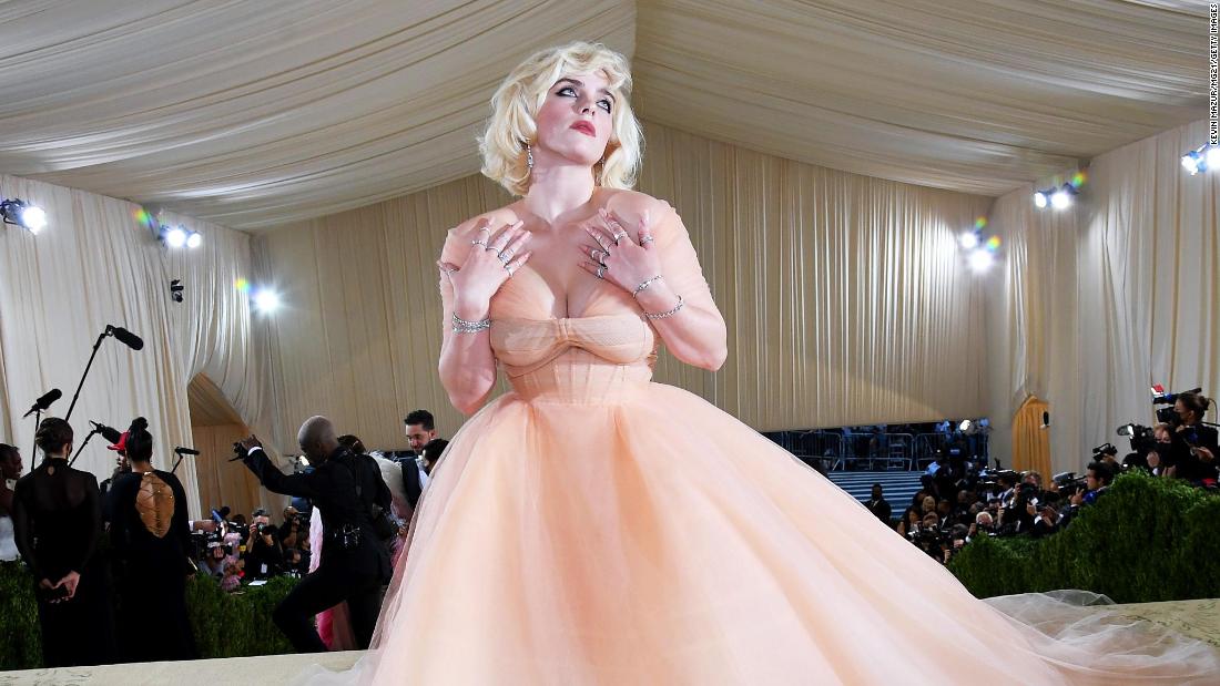 Met Gala co-chair Billie Eilish arrived in a voluminous peach Oscar de la Renta gown and the bleach-blonde hair she&#39;s been wearing since she released her sophomore album &quot;Happier Than Ever.&quot;