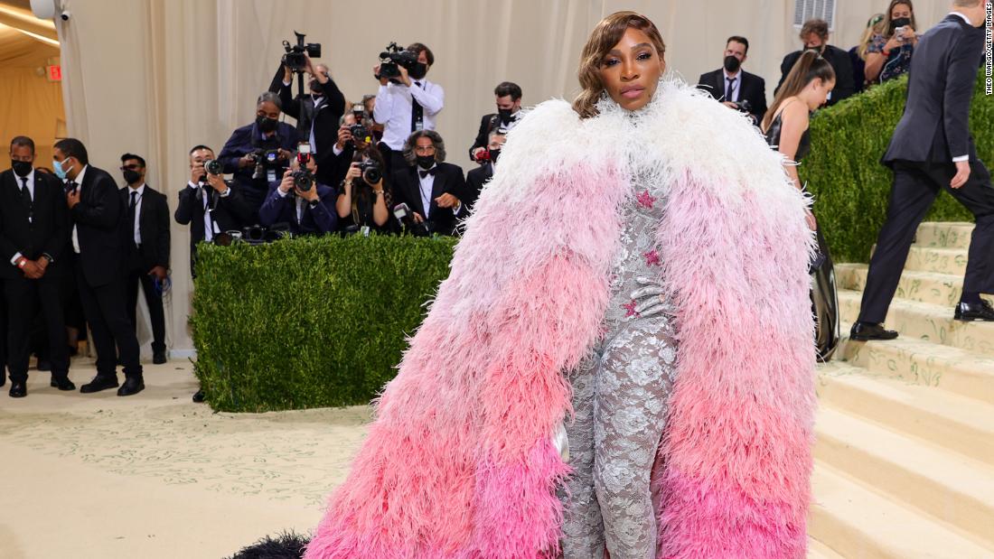 Serena Williams told E! that her outfit was &quot;superhero&quot; inspired. She wore a lace silver bodysuit with gloves underneath an opulent pink and white ombré feather cape.