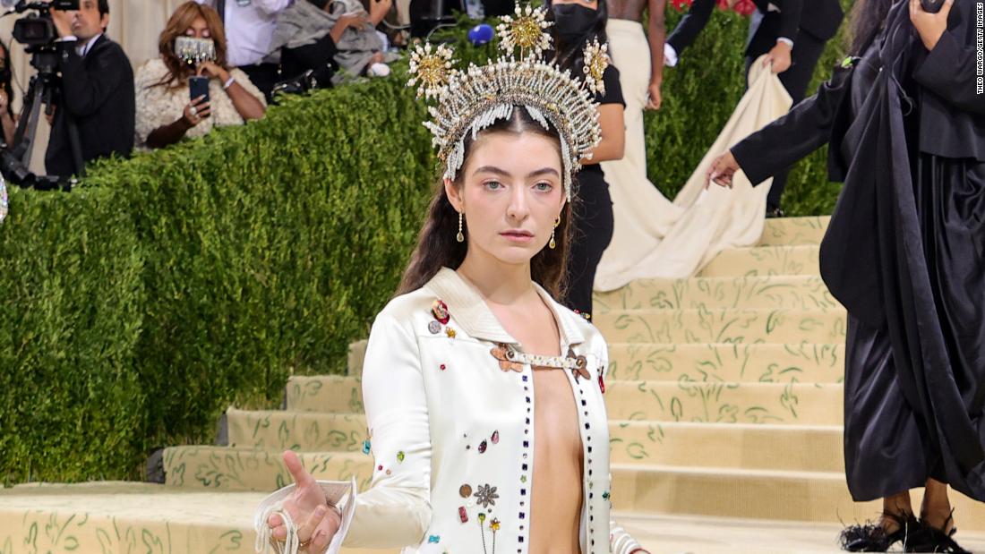 Singer Lorde, who recently released her album &quot;Solar Power,&quot; attended wearing a jeweled crown which appeared to feature sun-shaped motifs. She wore a custom embellished Bode gown and carried a small fringed bag. 