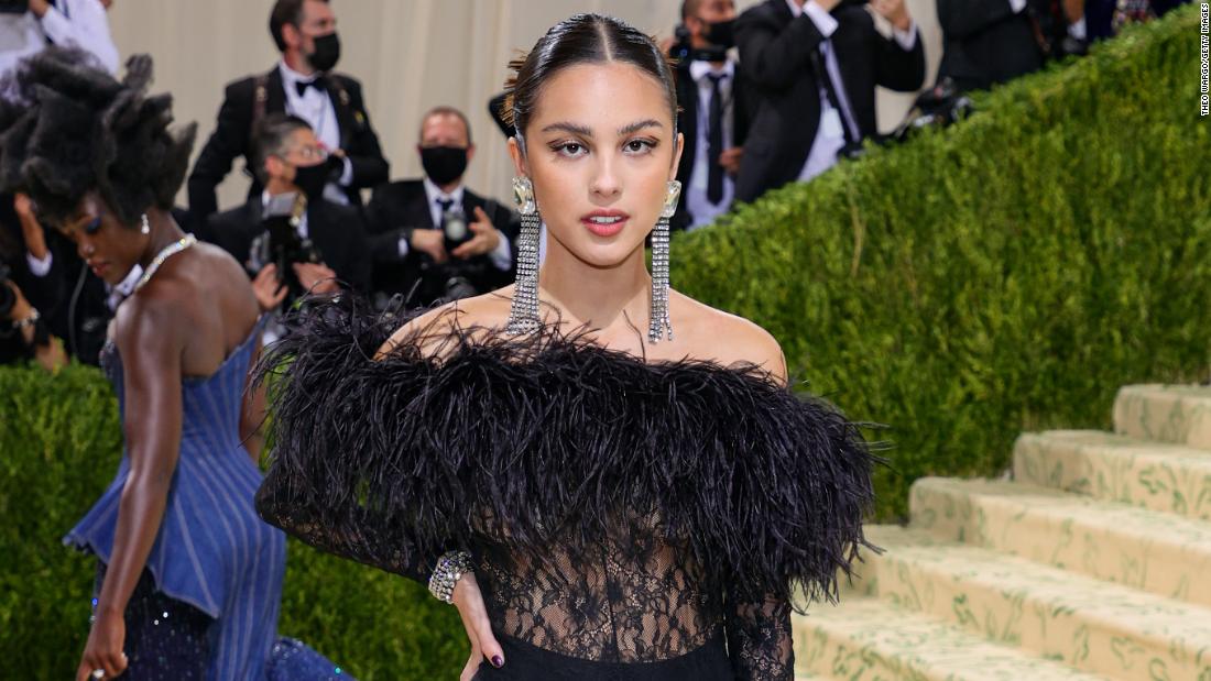 &quot;Good 4 U&quot; singer Olivia Rodrigo made her Met Gala debut dressed in a sheer feather and lace Saint Laurent jumpsuit. She paired the look with a pair of chunky black platform heels.