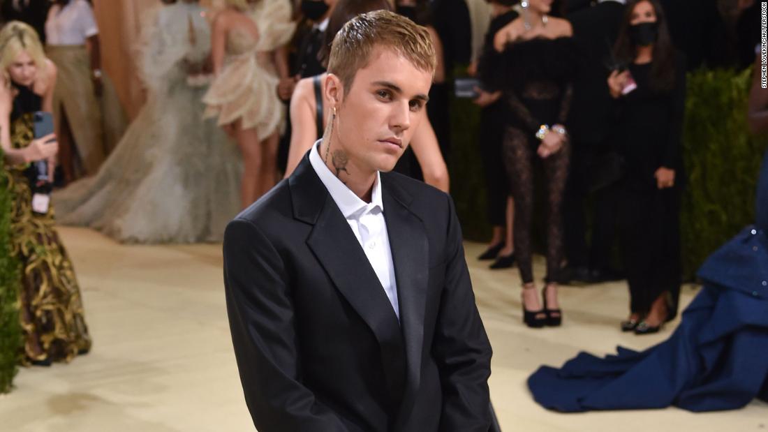 Justin Bieber, who attended with his wife Hailey, opted for a streamlined black and white evening look by his own fashion line Drew House. He was also seen carrying a bag from the label to the Met Gala and wore Air Force 1 sneakers, customized with Drew House branding.