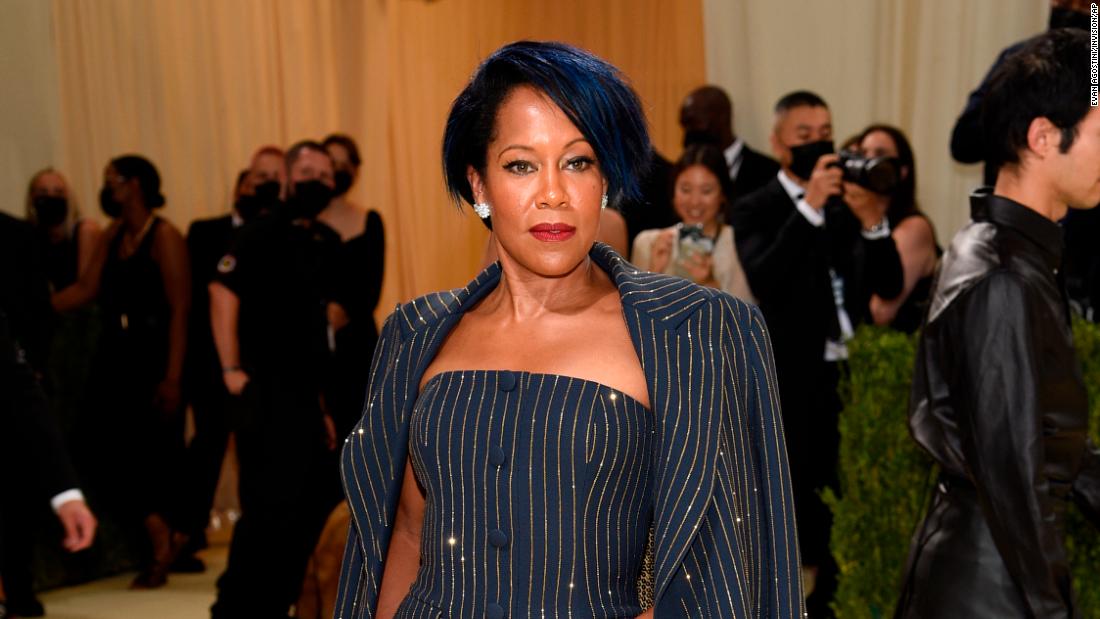 Regina King joined Michael Kors at the venue, where she was snapped wearing a sparkling pin-striped outfit. Featuring a gold sequined lining, navy overcoat and form-fitting gloves, she matched the look with a streak of color in her hair.
