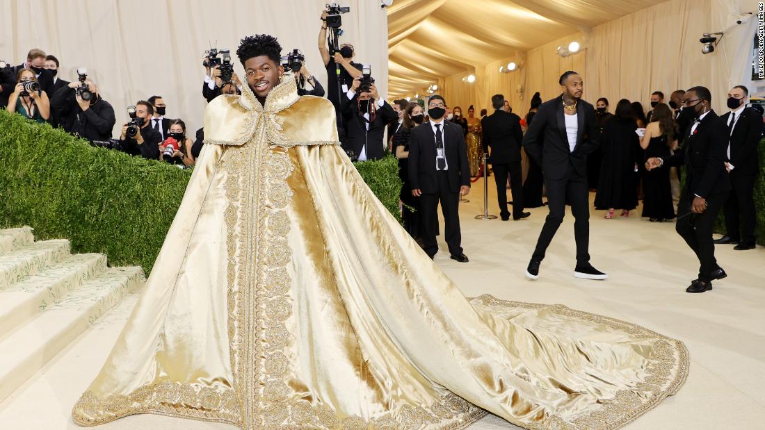 Lil Nas X brought spectacle to the red carpet with not one but three different looks by Versace. First, he wore this regal golden cloak with delicate embroidery around the hem and collar.&lt;br /&gt;