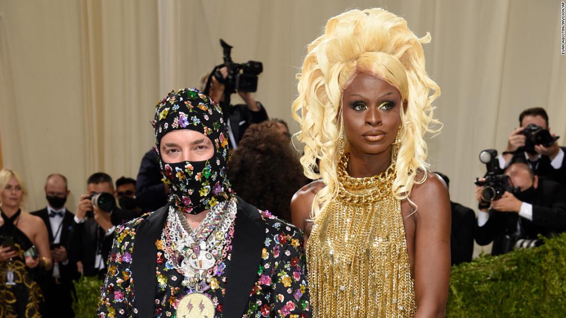 J Balvin and &quot;RuPaul&#39;s Drag Race&quot; winner Symone both arrived wearing Moschino. Balvin wore a suit and matching balaclava covered in florals, alongside a stack of necklaces. In contrast, Symone chose a fringed golden dress which trailed all the way to the floor. &lt;a href=&quot;https://www.cnn.com/interactive/2021/09/style/symone-met-gala-cnnphotos/&quot; target=&quot;_blank&quot;&gt;Related: Getting Met Gala-ready with &#39;Drag Race&#39; star Symone&lt;/a&gt;