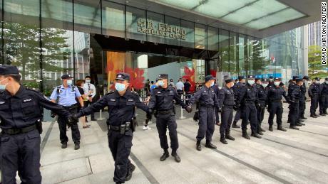 Security personnel form a human chain as they guard outside the Evergrande&#39;s headquarters, where people gathered to demand repayment of loans and financial products, in Shenzhen, Guangdong province, China September 13, 2021. REUTERS/David Kirton