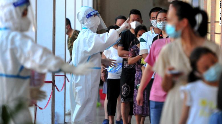 Residents queue to undergo nucleic acid tests for coronavirus in Xianyou county, Putian city, in China&#39;s eastern Fujian province on September 13.